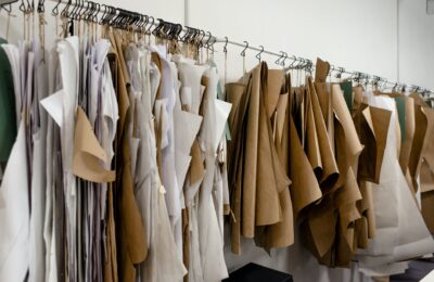 assorted sewing patterns on hangers inside tailor atelier