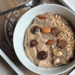 peanut butter smoothie bowl recipe in a white bowl placed on a grey tray