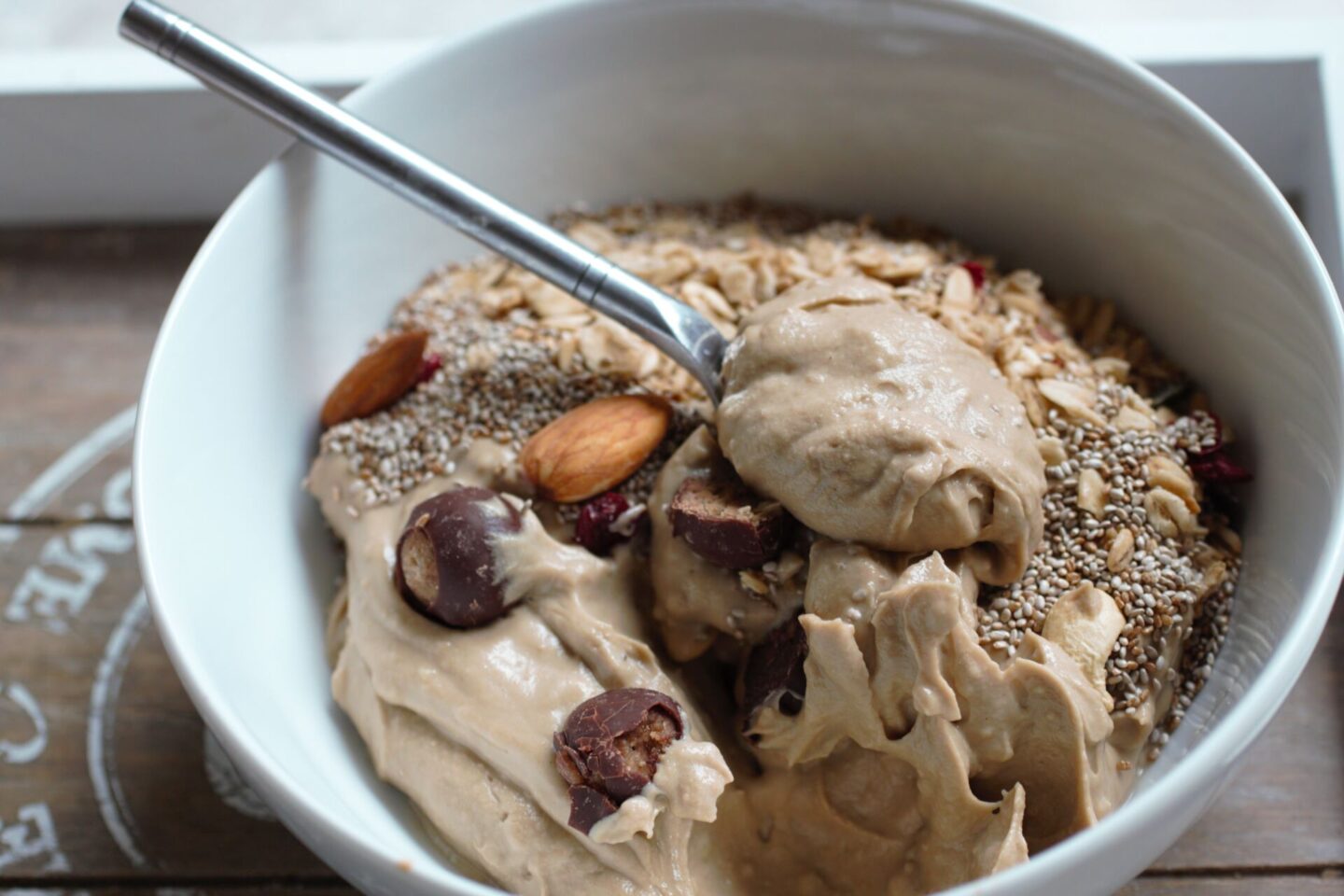 bowl of peanut butter smoothie bowl recipe with some on a spoon to show the creamy texture