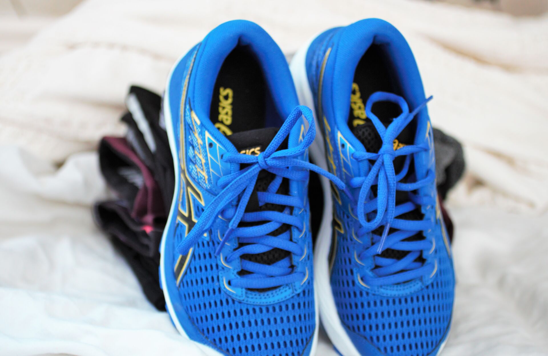 running shoes placed on a white sheet