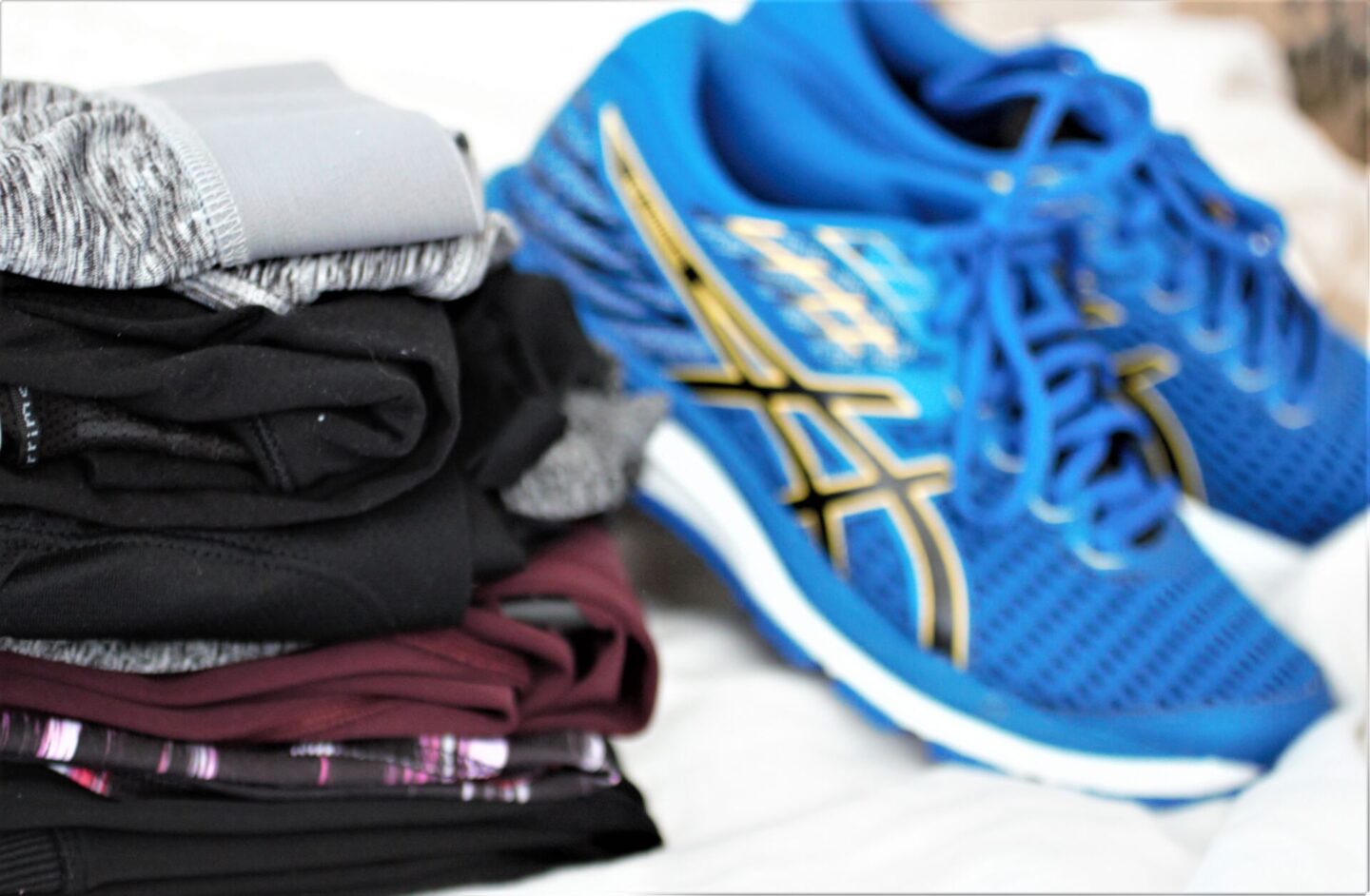 some shoes and a pile of activewear