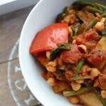 a white bowl with the vegetable curry recipe in