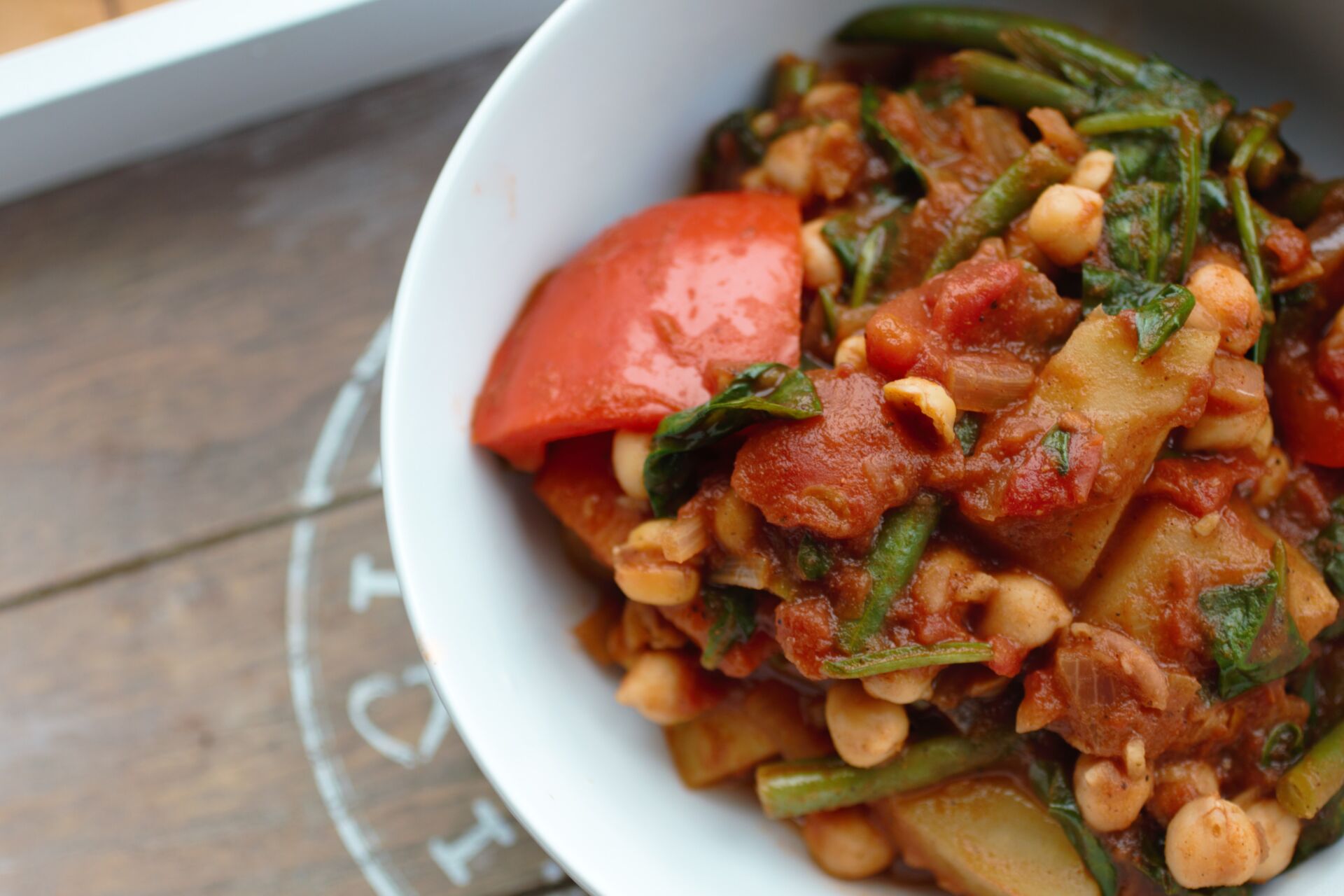 a white bowl with the vegetable curry recipe in