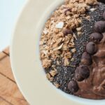 mocha smoothie bowl recipe in a bowl topped with granola and chocolate chips