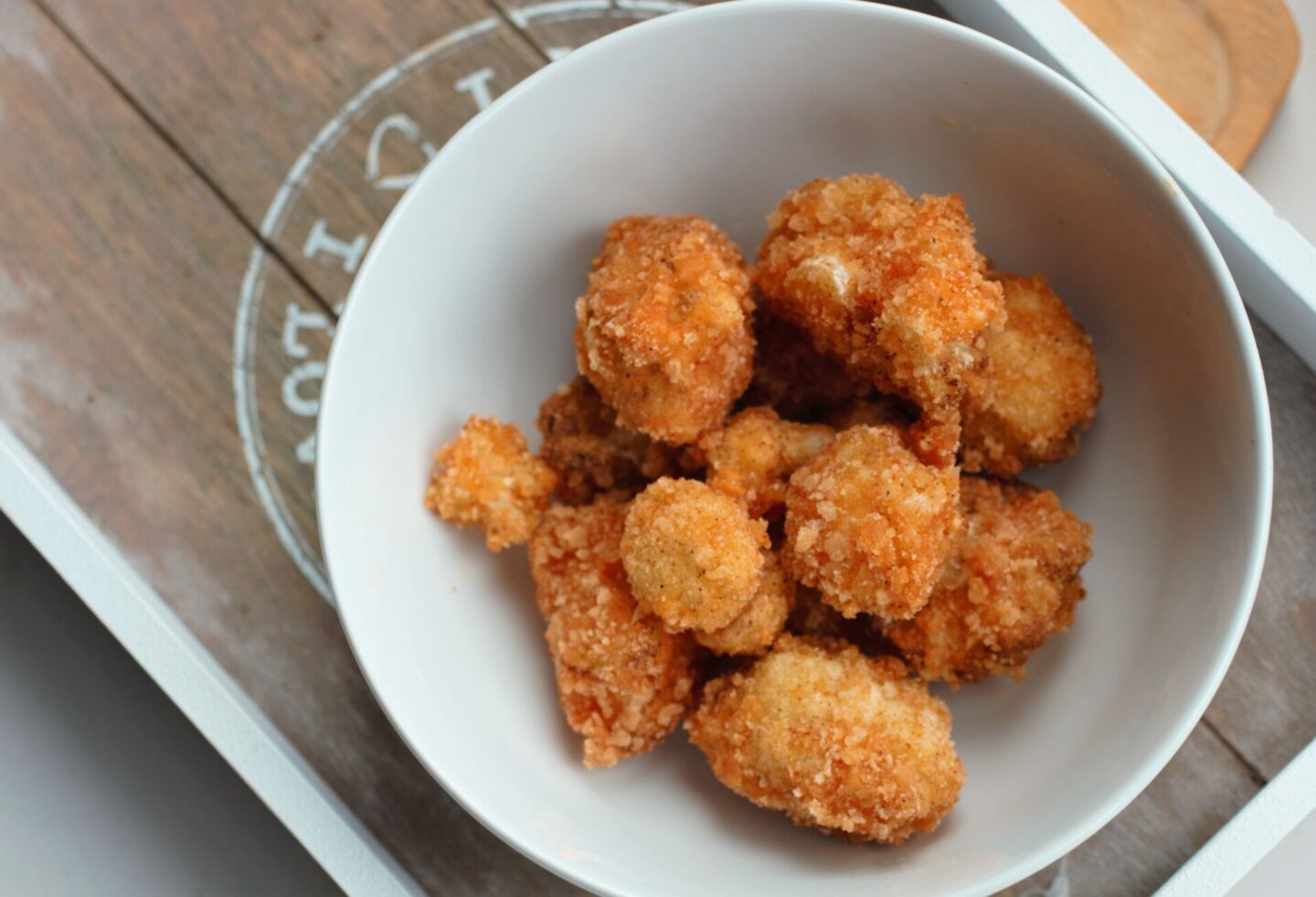 white bowl filled with fried popcorn cauliflower recipe pieces