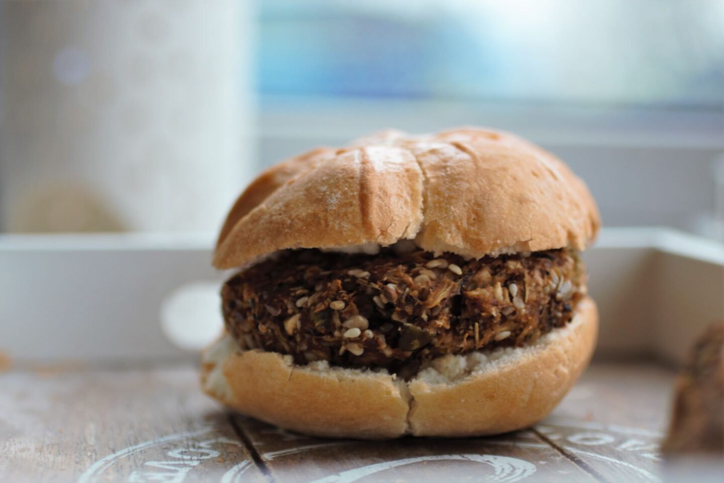 celeriac mushroom burgers recipe in a schar hamburger roll on a grey tray