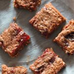 slices almond butter jam flapjacks on a sheet of baking paper
