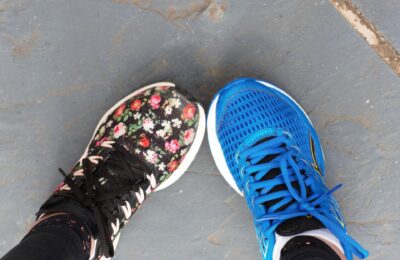me wearing an old running shoe on my left foot and one of my new running shoes on my right foot