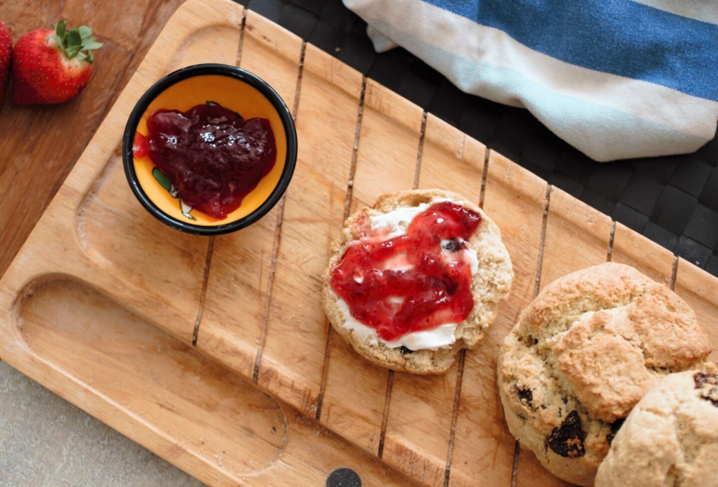 strawberry scones recipe - scones on a tray with a pot of jam