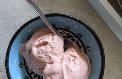 small bowl with two scoops of strawberry ice cream recipe in it