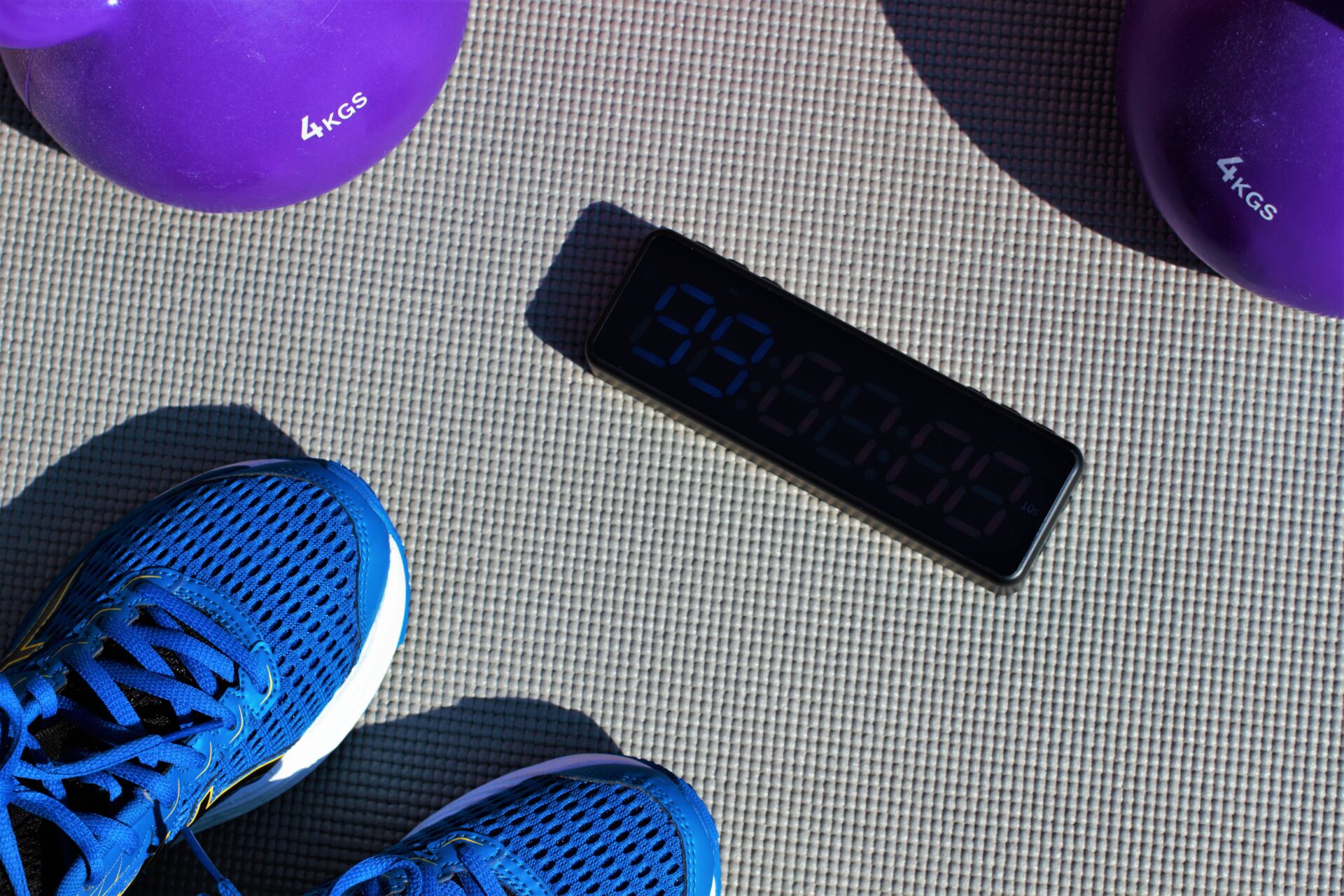 wotkout timer surrounded by fitness equipment