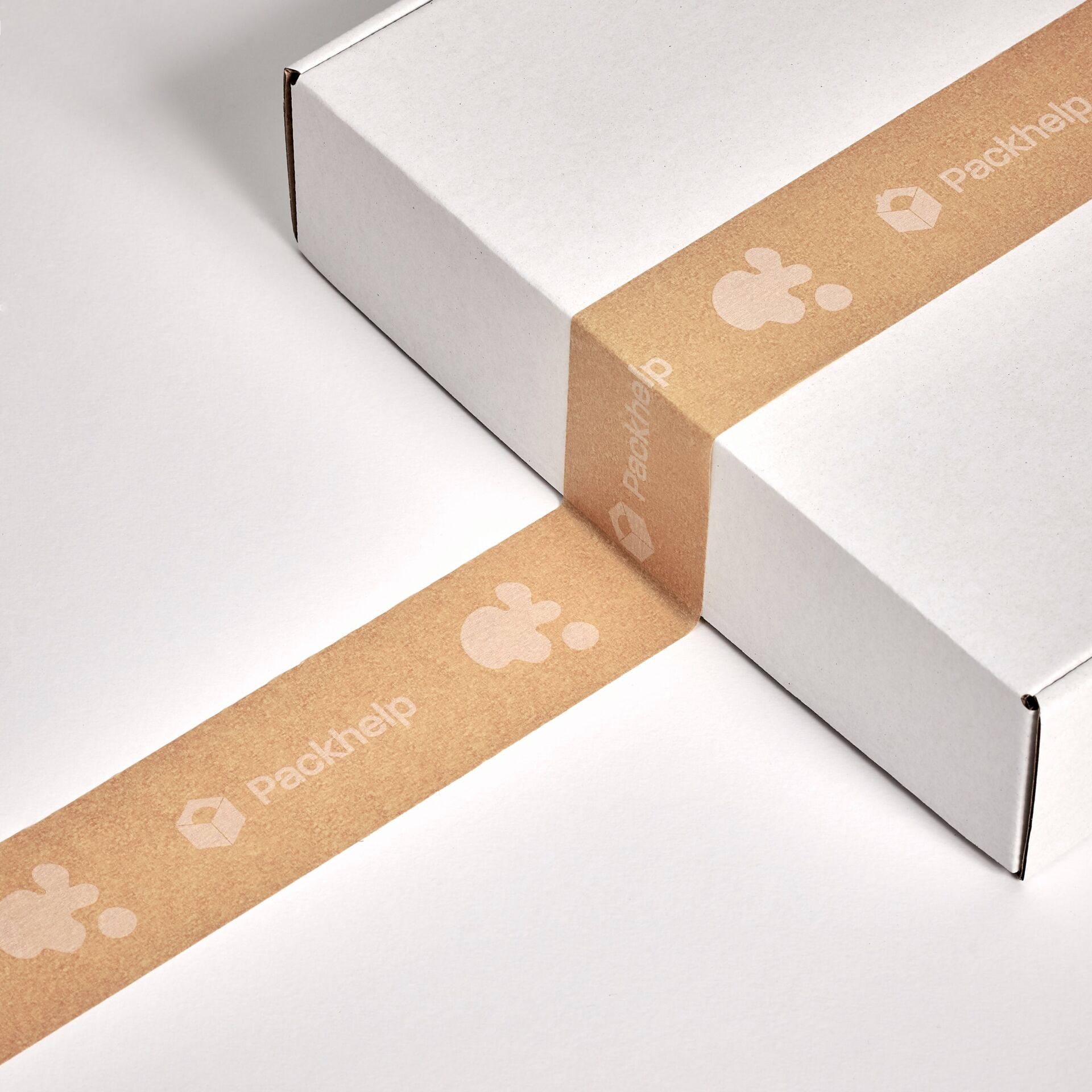 a white cardboard box with brown tape, an example of eco-friendly packaging