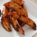 a close up shot of some chipotle fries on the side of a white plate