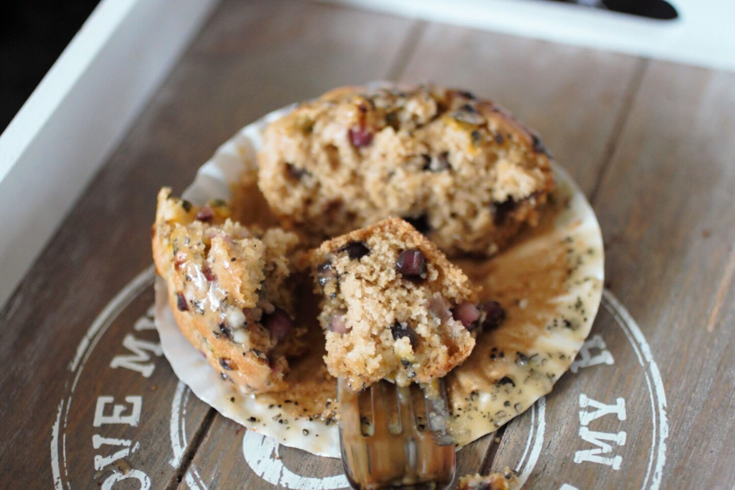 a pomegranate and passionfruit cupcake, sliced open to show the fluffy texture with a fork in one of the pieces