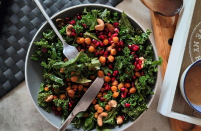 closer shot of pomegranate & passionfruit salad bowl with a knife and fork in it