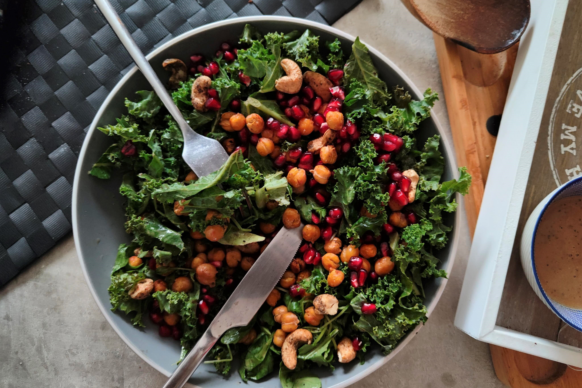 closer shot of pomegranate & passionfruit salad bowl with a knife and fork in it