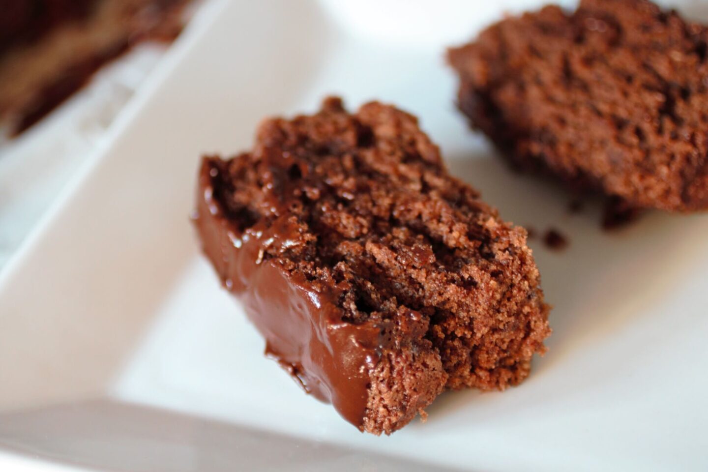 a slice of chocolate orange loaf on a white plate