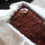 freshly iced chocolate orange loaf in the loaf tin