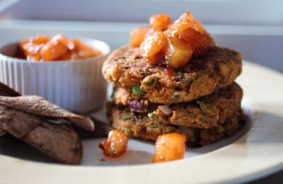 plate of Indian chickpea fritters topped with pineapple chutney