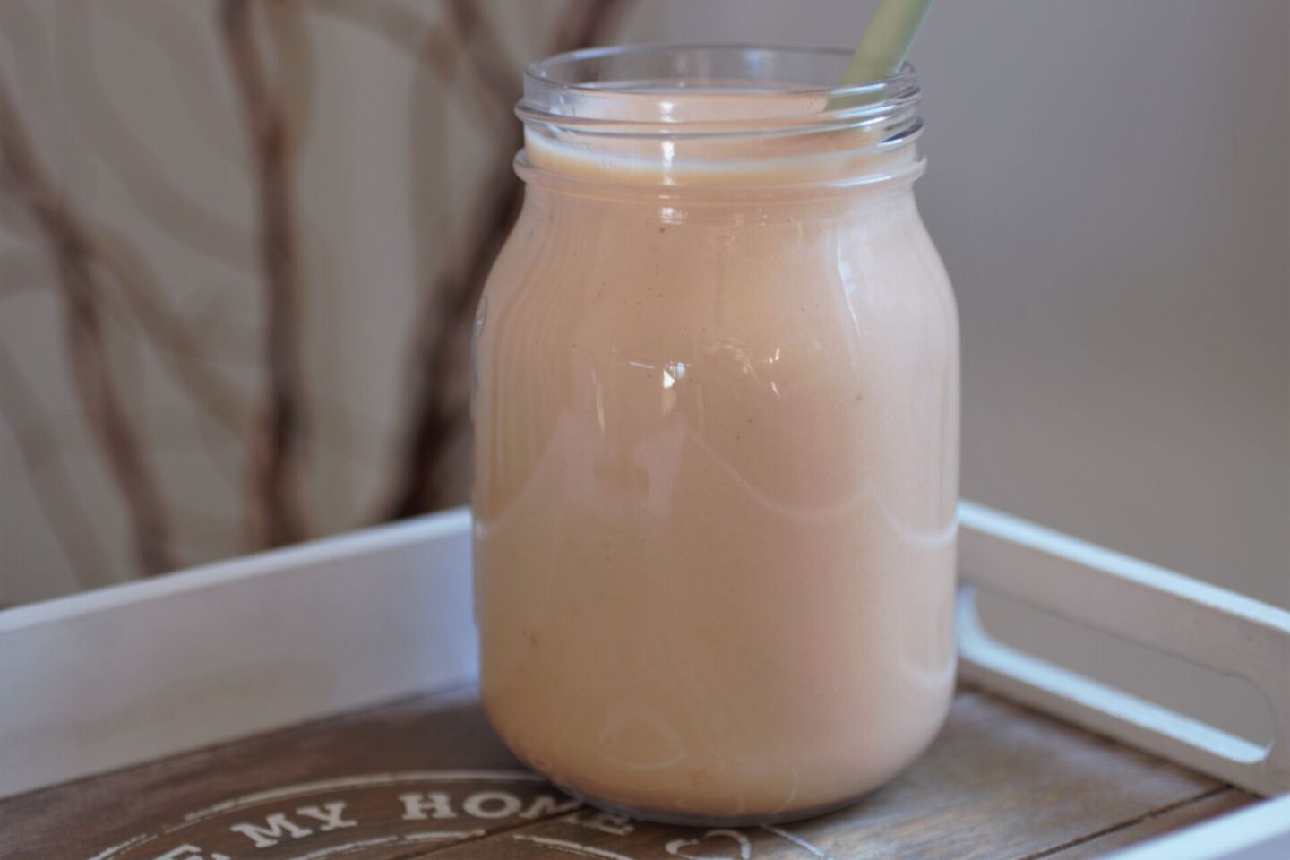 pineapple smoothie recipe in a glass kilner jar against a white wall