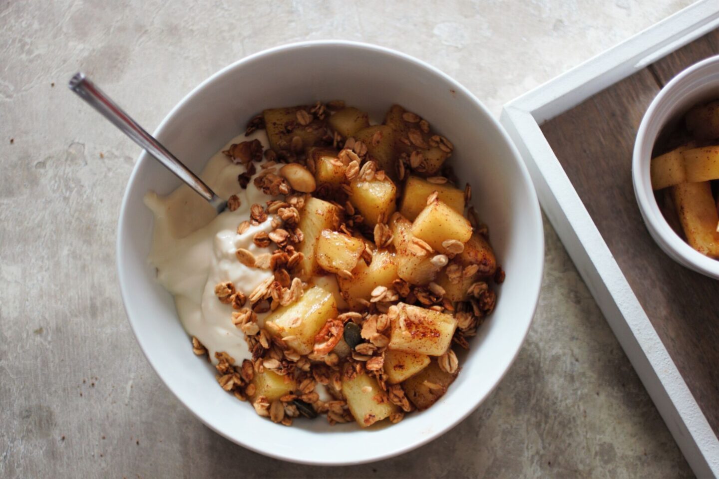 bowl of sweet fried mango and yoghurt with granola