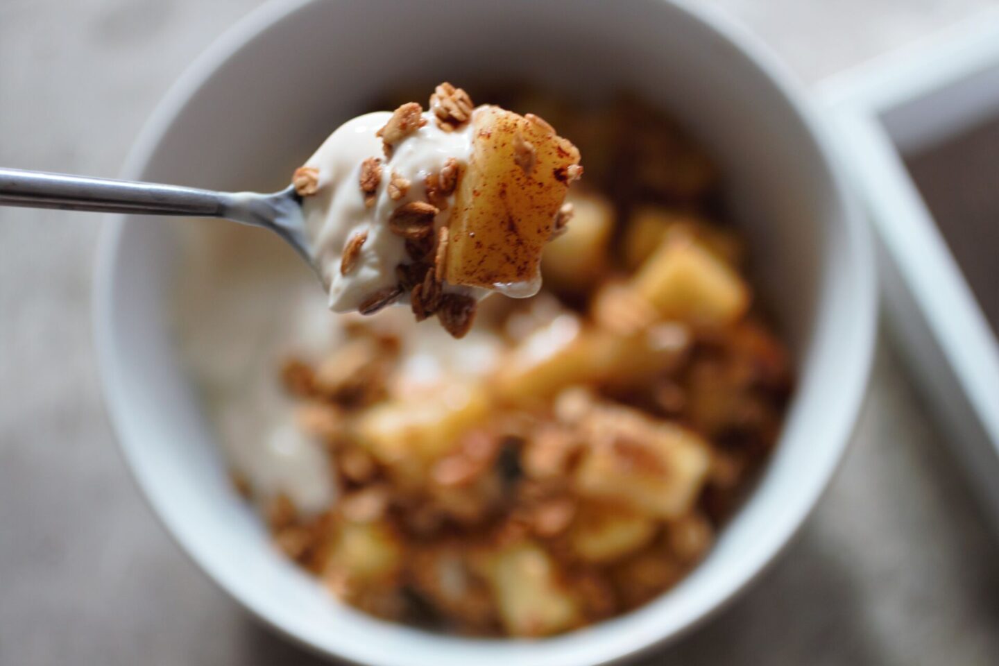 sweet fried mango and yoghurt on a spoon