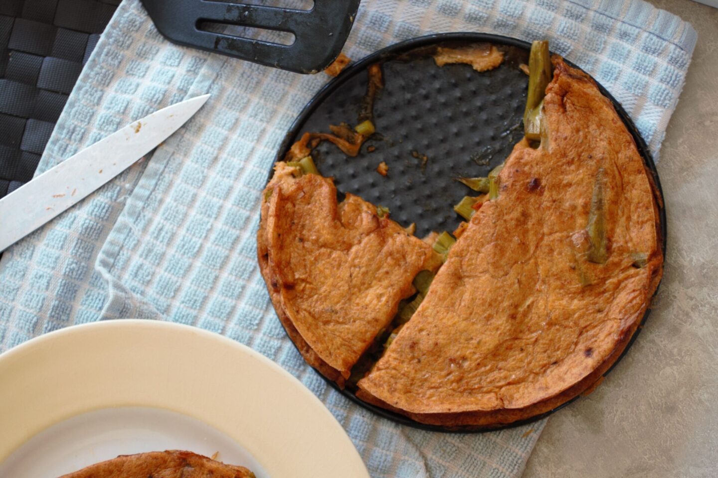 asparagus frittata recipe dish, with a slice missing, shot from above