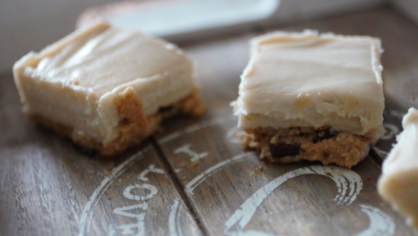 cookie dough cheesecake slices shot from the side to show the cookie dough base