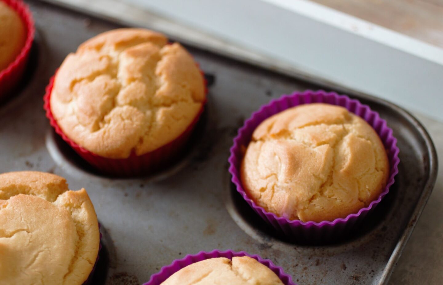 a cupcake tray with freshly baked cupcakes in it