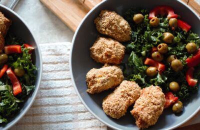 a bowl of sweet potato nuggets with salad
