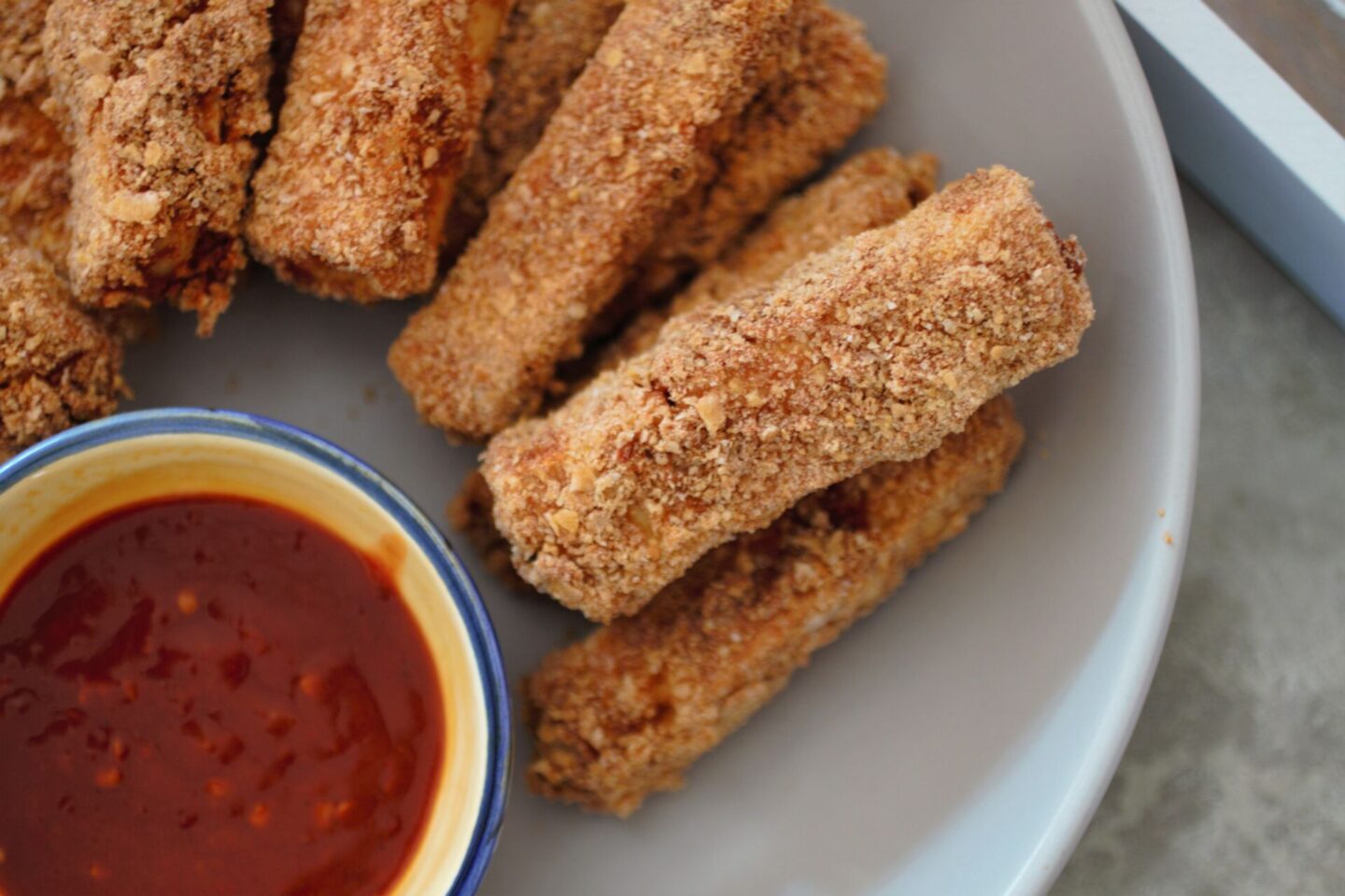 close up shot of a few tofu fingers in a bowl