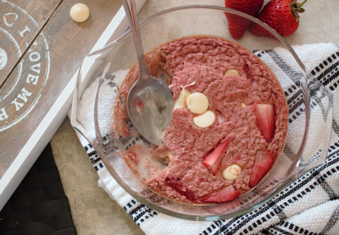 Vegan Strawberry Cheesecake Baked oats with a spoon in the dish