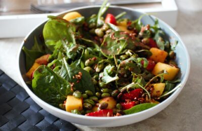 a bowl of strawberry mango salad recipe on a table