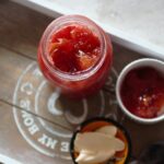 a pot of peach jam recipe and a jar of peach jam