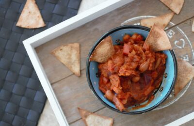 tray with pot of pumpkin chilli dip and homemade tortilla chips