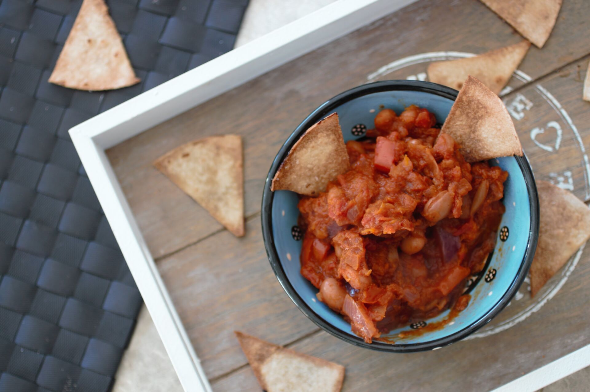 tray with pot of pumpkin chilli dip and homemade tortilla chips