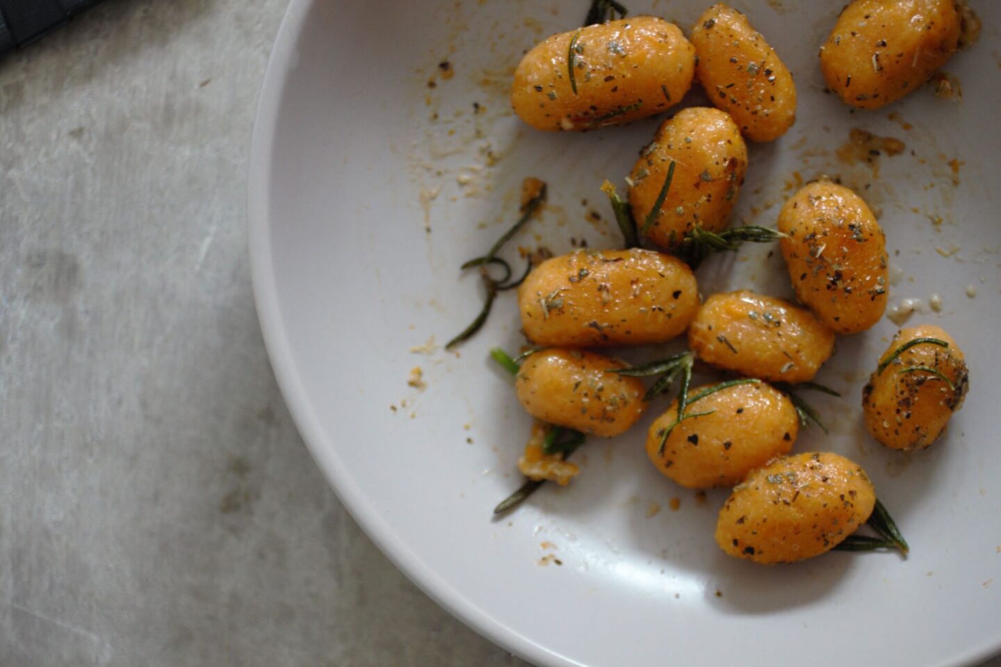 bowl of pumpkin gnocchi recipe with rosemary and sage