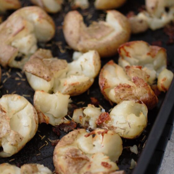 Smashed Potatoes Recipe - roasting dish filled with smashed potatoes