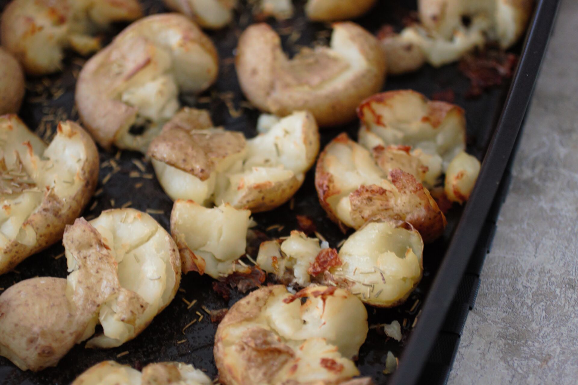 Smashed Potatoes Recipe - roasting dish filled with smashed potatoes