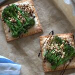 two freshly cooked broccoli tarts on a baking sheet