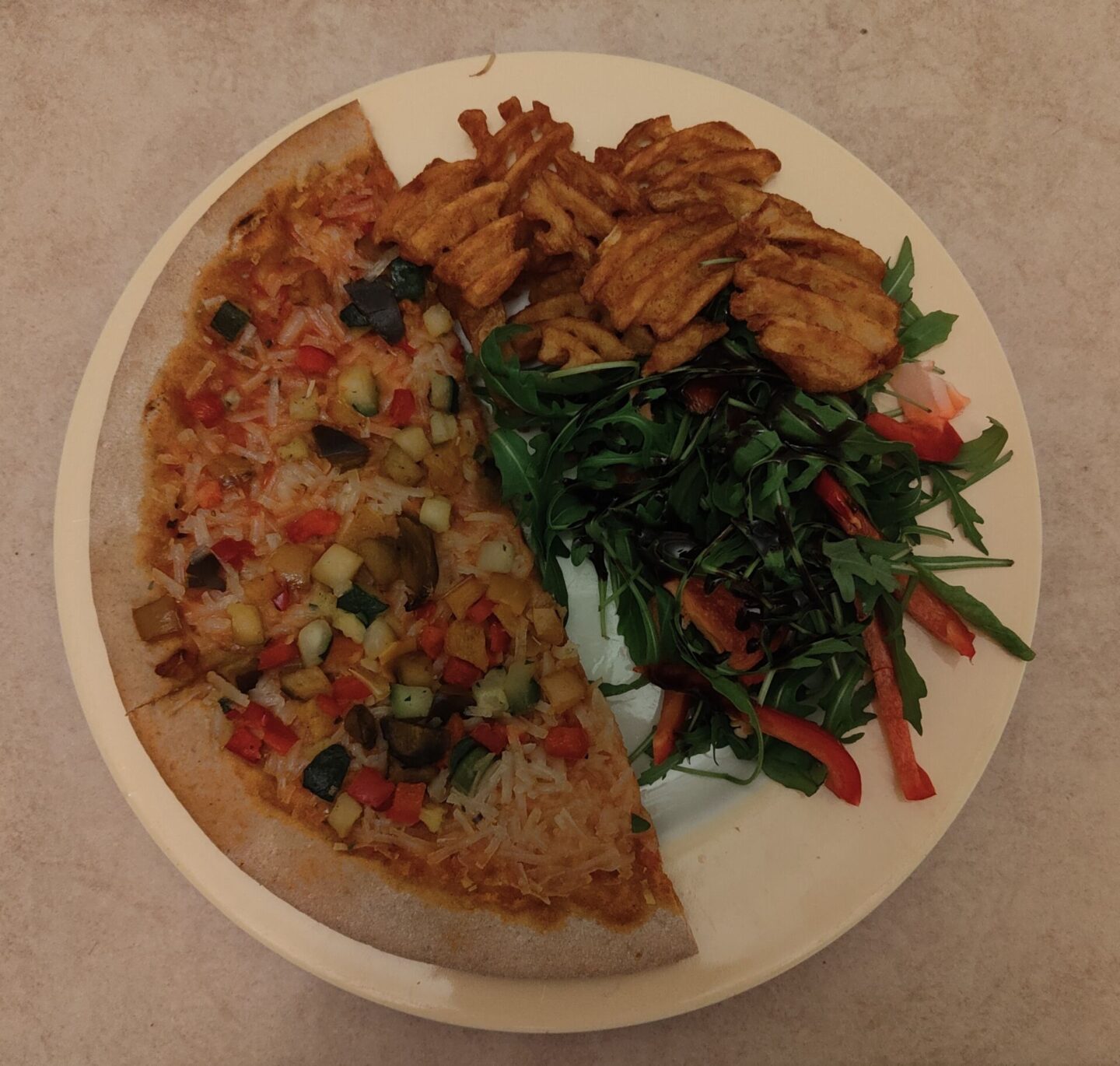 Schar vegan pizza looking a little sad with some waffle fries and salad