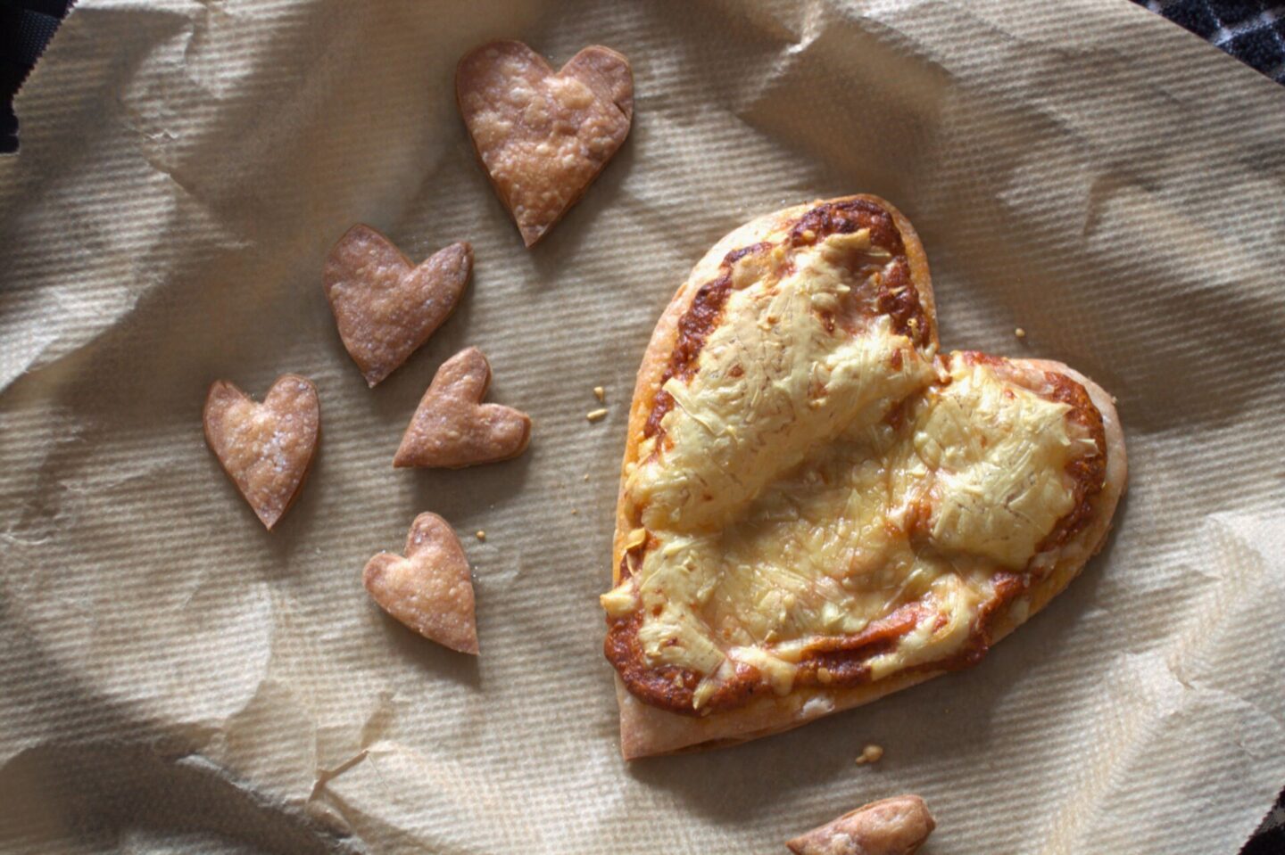 freshly cooked Valentine's Pizza Tart recipe and some puff pastry hearts on a baking tray