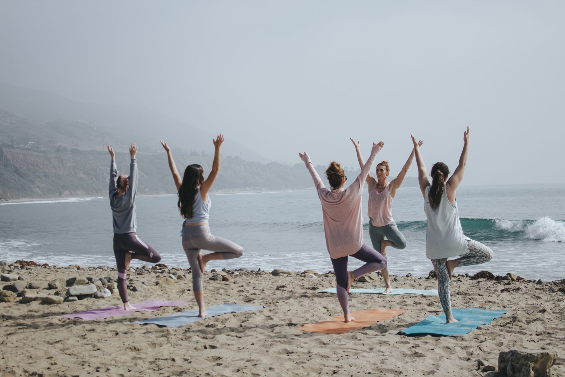 Tips to help you handle hot flashes - women on a beach doing yoga