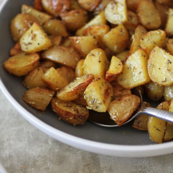 a bowl of parmentier potatoes with a serving spoon in them