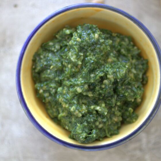 a pot of rocket & basil peso recipe against a grey marl background