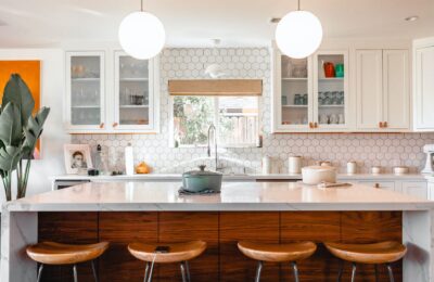 a kitchen island with stools and a view of the surfaces behind it