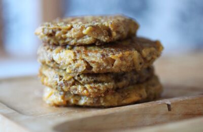 stack of butternut squash fritters on a wooden board