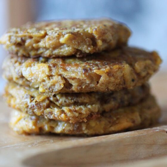stack of butternut squash fritters on a wooden board