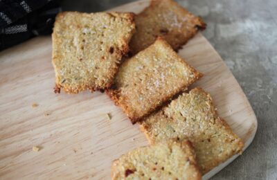 a few chilli and rosemary crackers on the end of a wooden tray