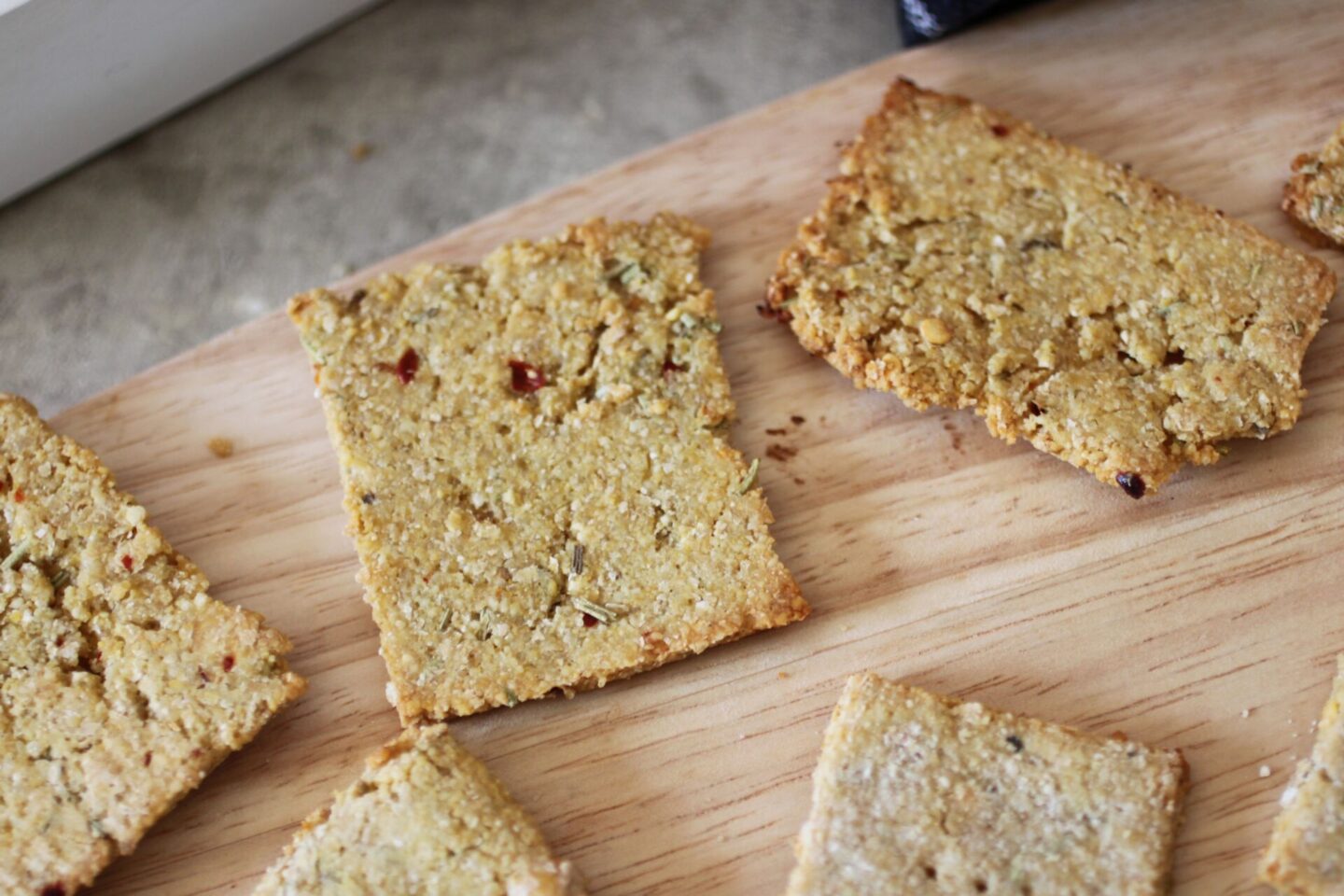 some chilli and rosemary crackers spread across a tray